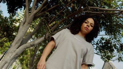 a woman standing in front of a tree