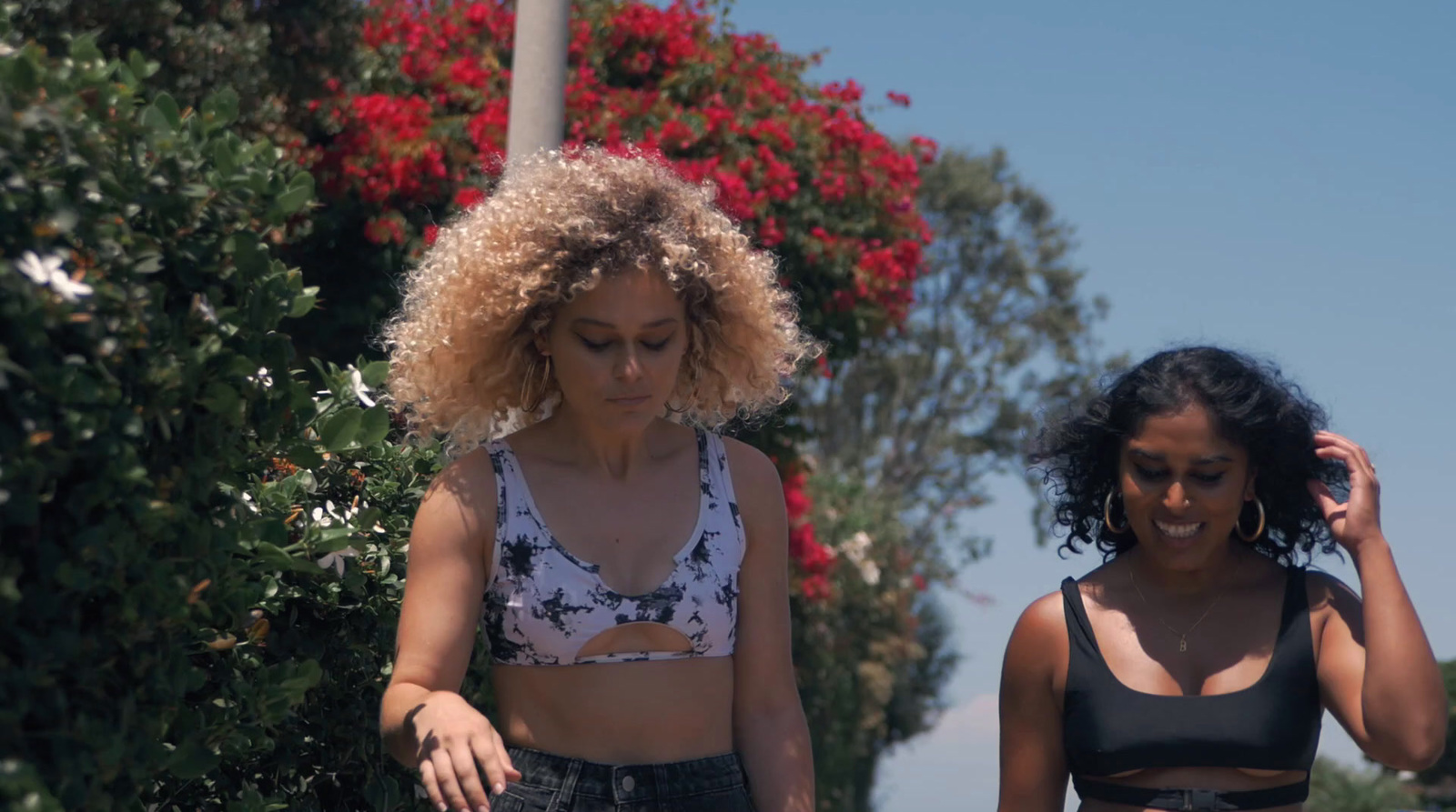 two women walking down a street next to each other