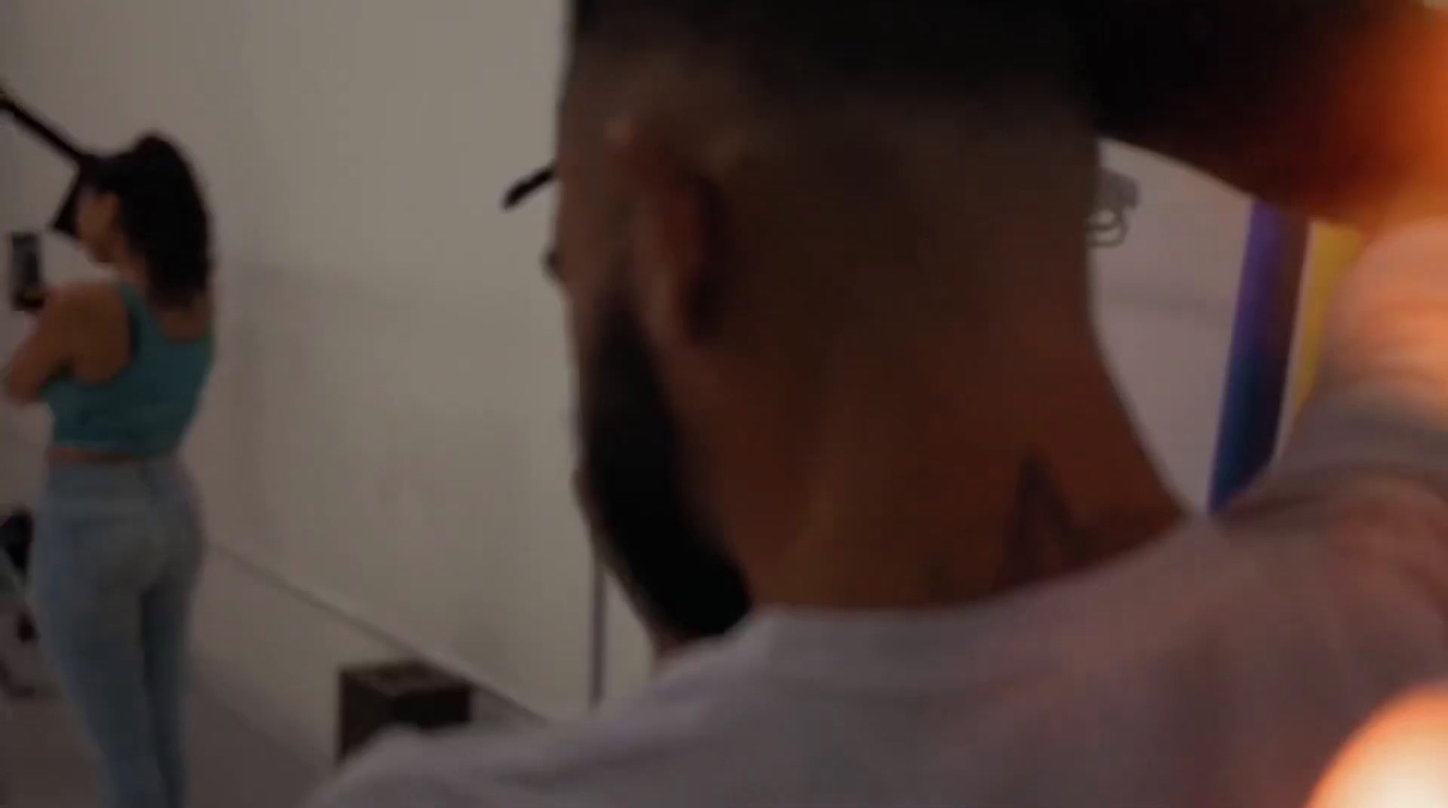 a man is brushing his hair in front of a mirror