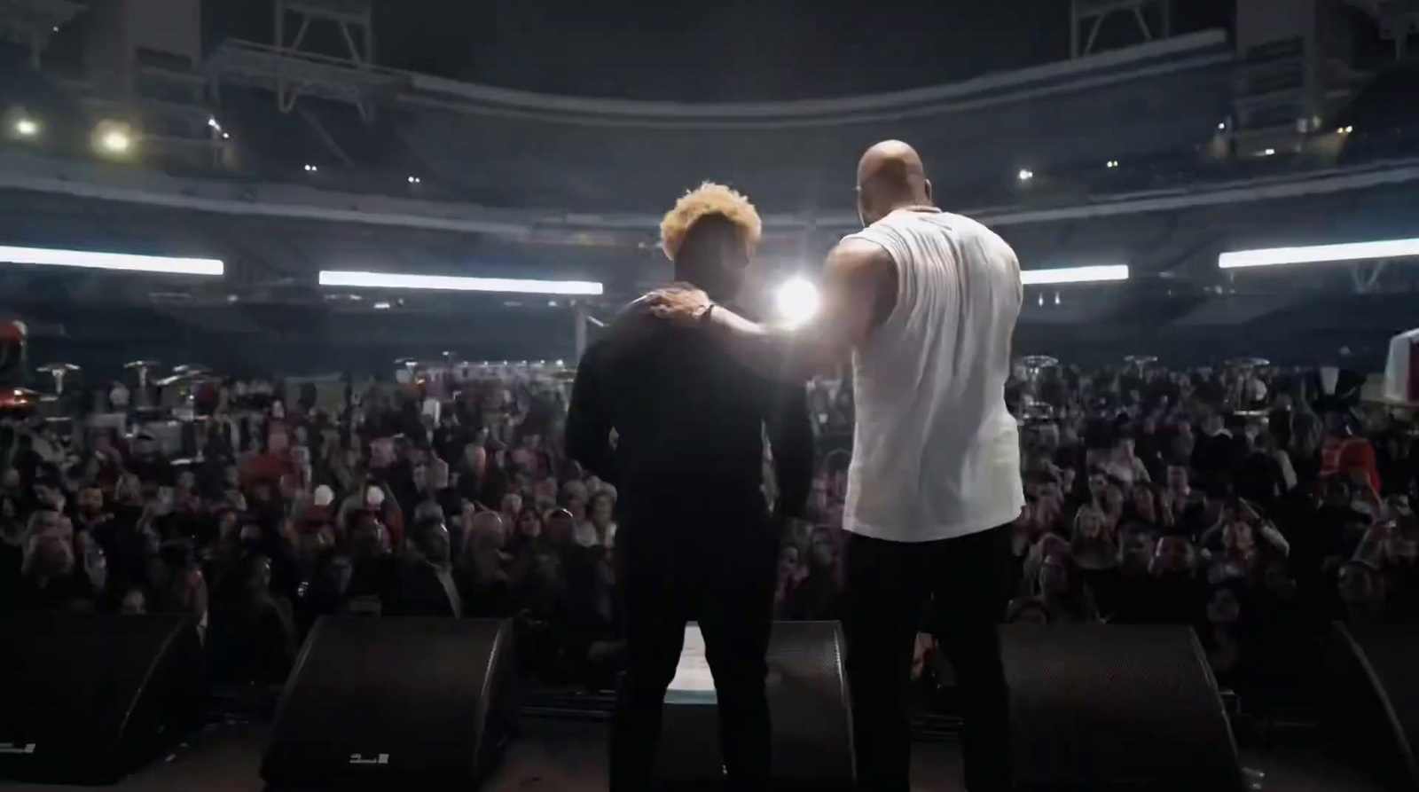 a couple of men standing on top of a stage