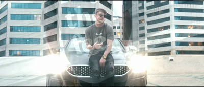 a man sitting on the hood of a car