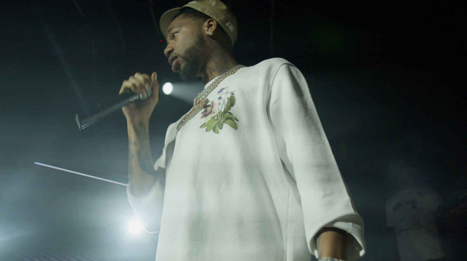 a man holding a microphone in his right hand