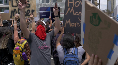 a group of people holding up signs in the air