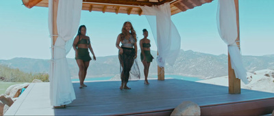 a group of women standing on top of a wooden platform