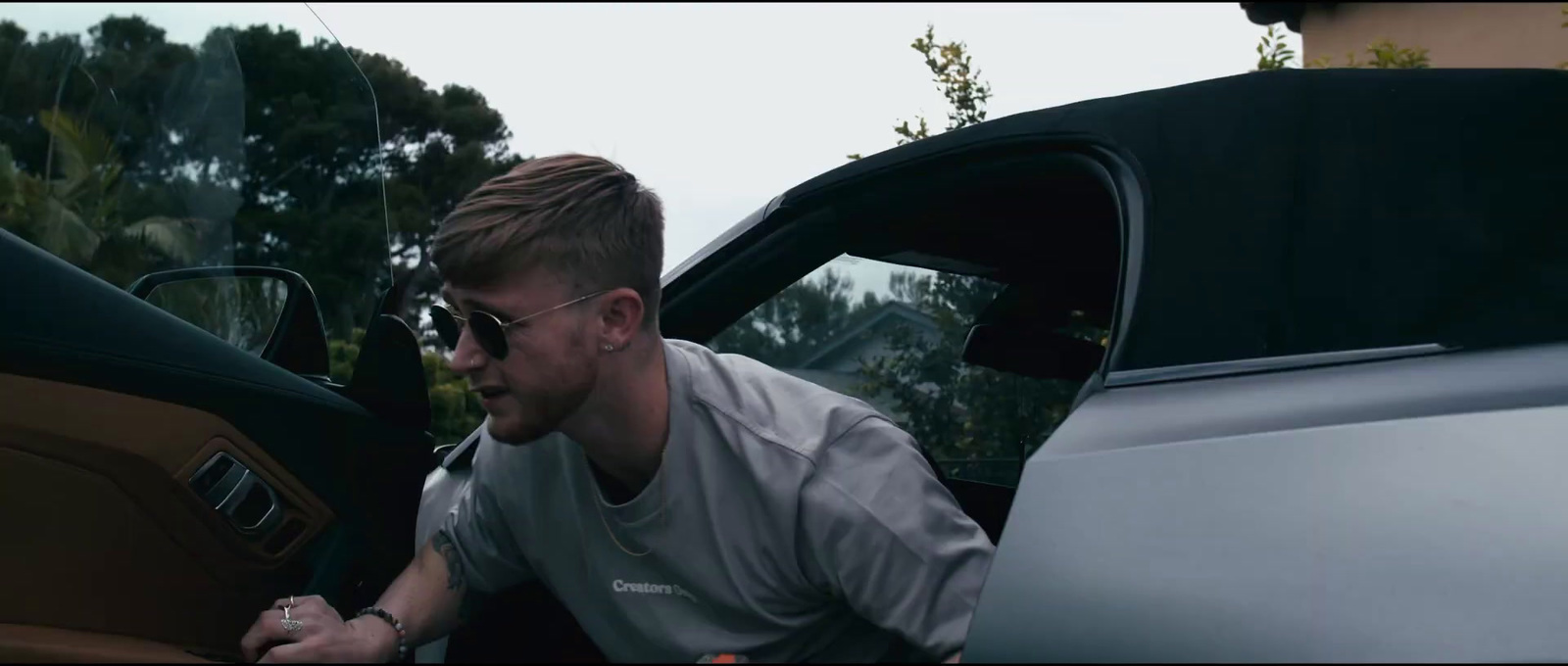 a man sitting in the driver's seat of a car