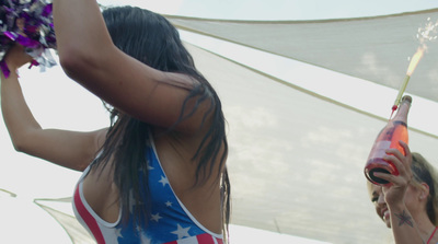 a woman in a bathing suit holding a bottle