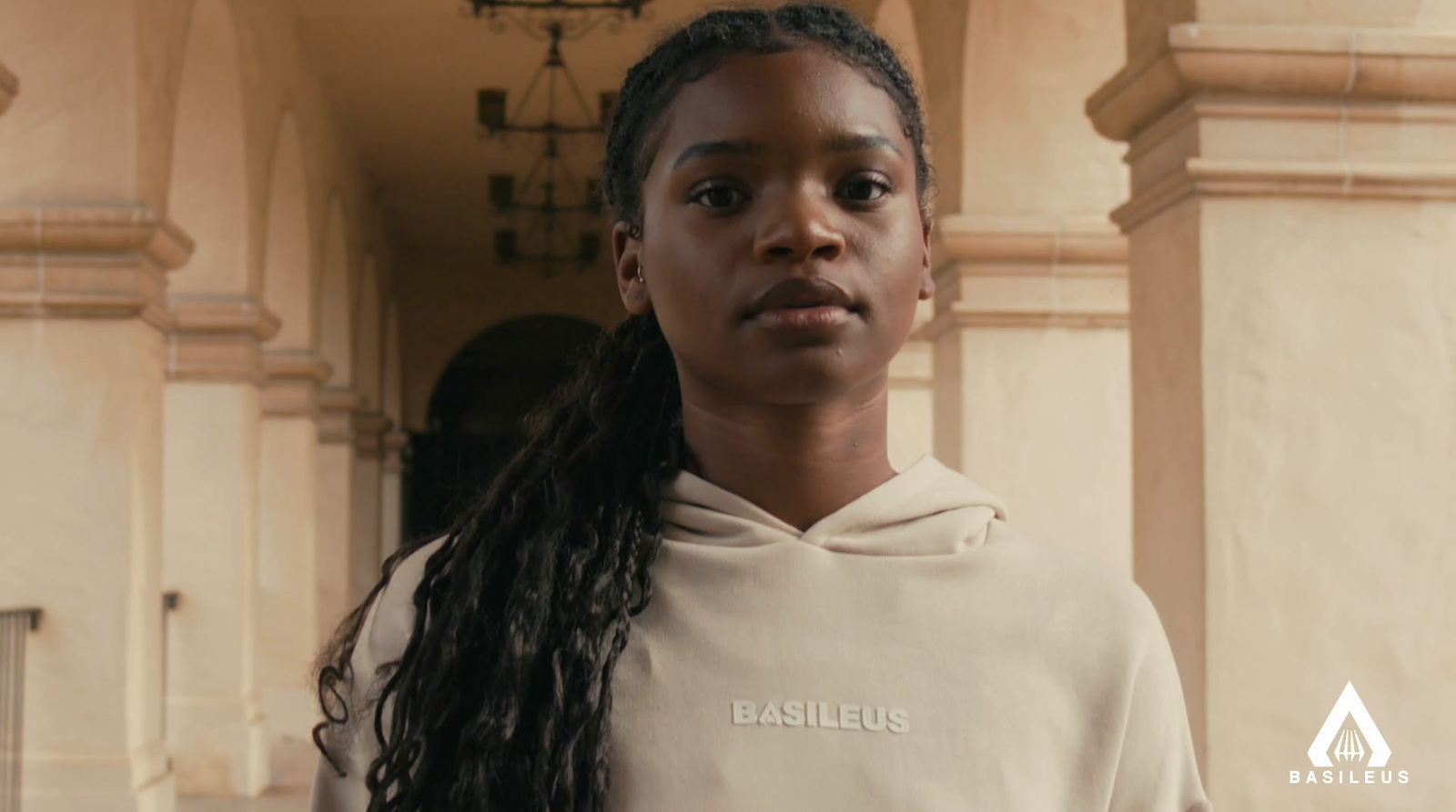 a woman with long hair wearing a white sweatshirt