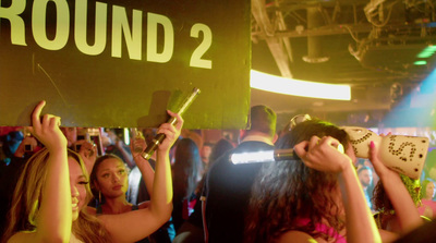 a group of people holding up signs at a party