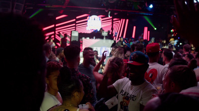 a crowd of people standing around a stage