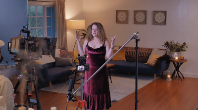 a woman standing in front of a camera in a living room