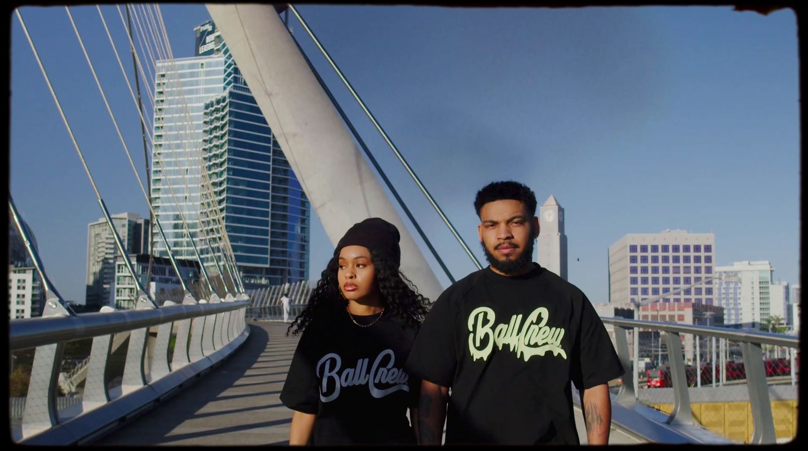 a man and a woman standing on a bridge