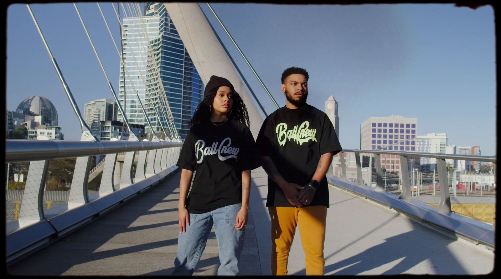 a man and a woman standing on a bridge