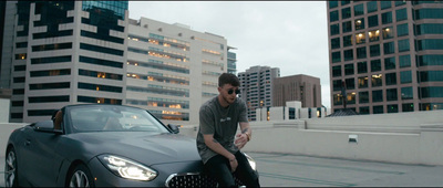 a man sitting on the hood of a car