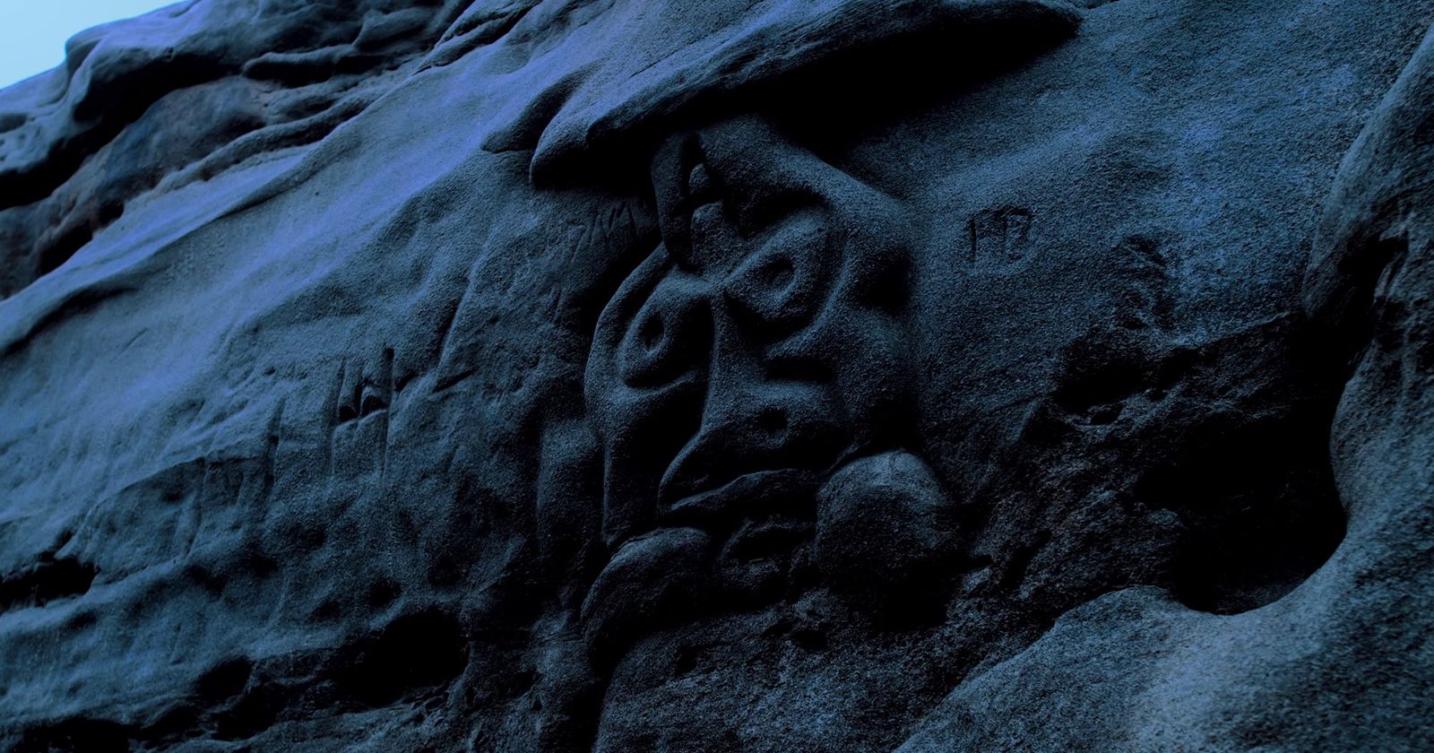 a rock face carved into the side of a mountain