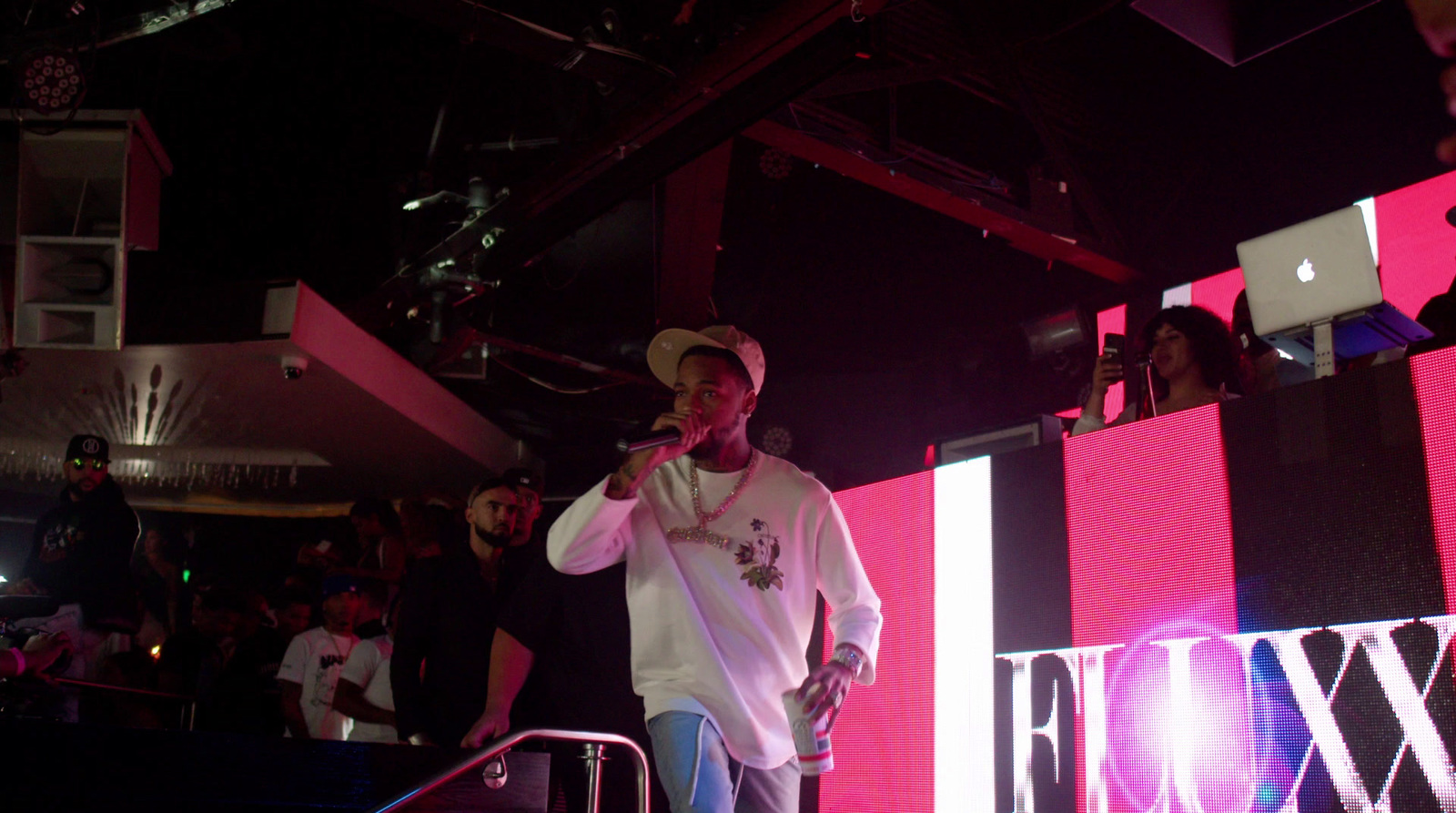 a man standing on a stage holding a microphone