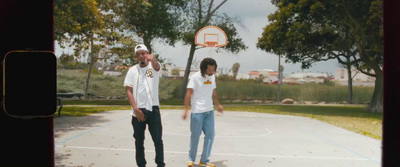 a couple of men standing on top of a basketball court