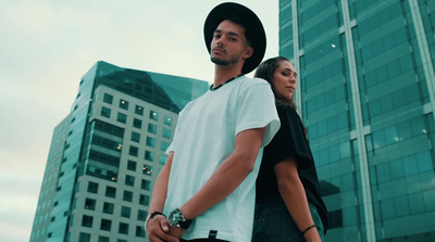 a man and a woman standing in front of a tall building