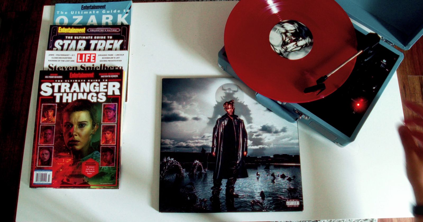 a red record player sitting on top of a table