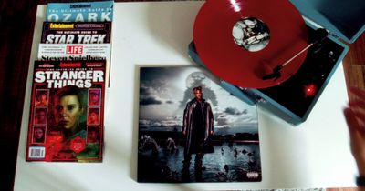 a red record player sitting on top of a table