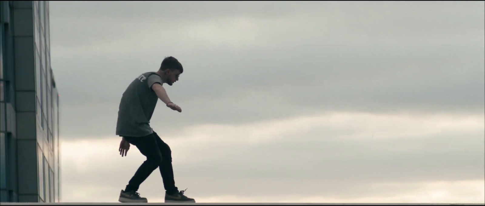 a man riding a skateboard down the side of a tall building