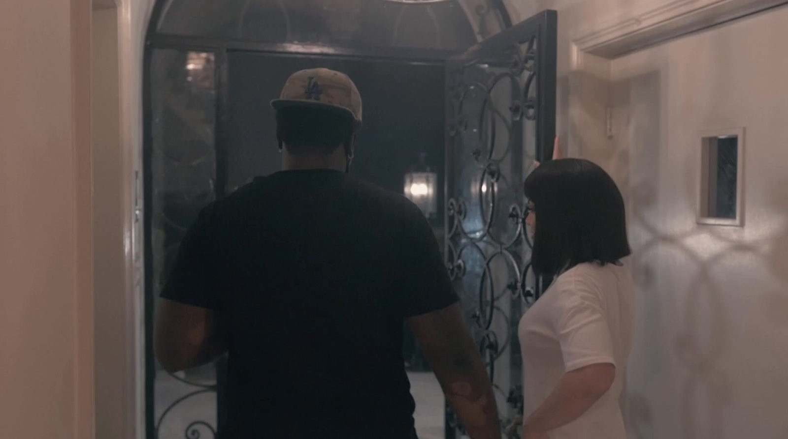 a man and a woman walking into a doorway