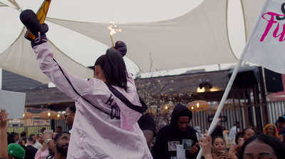 a woman holding a cross and a flag