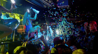 a group of people standing around a room filled with confetti