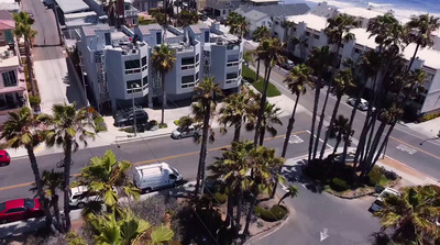 an aerial view of a street with palm trees