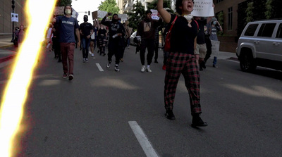 a group of people walking down a street