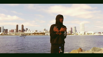 a man standing next to a body of water