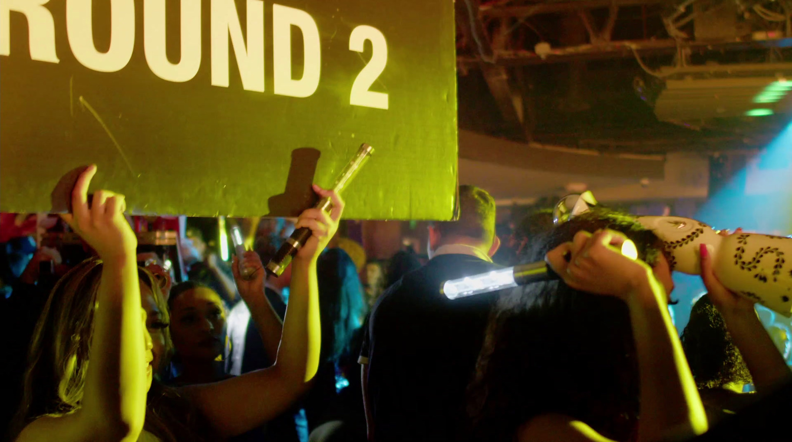 a group of people holding up signs at a party