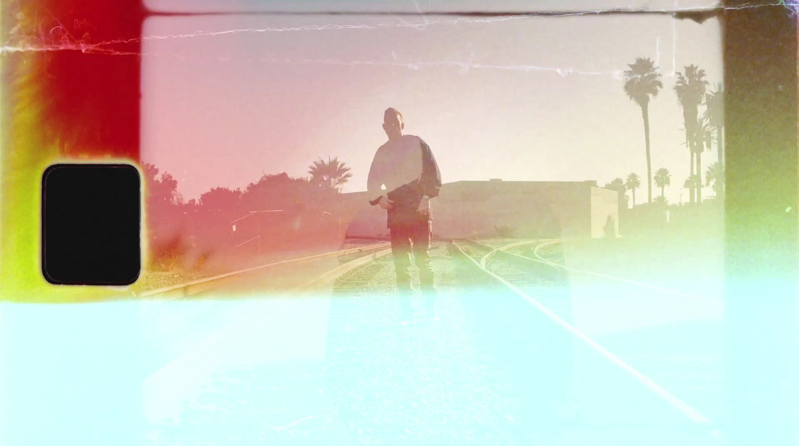 a man riding a skateboard down a train track