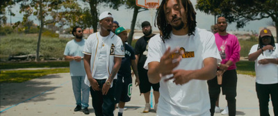 a group of young men standing around each other