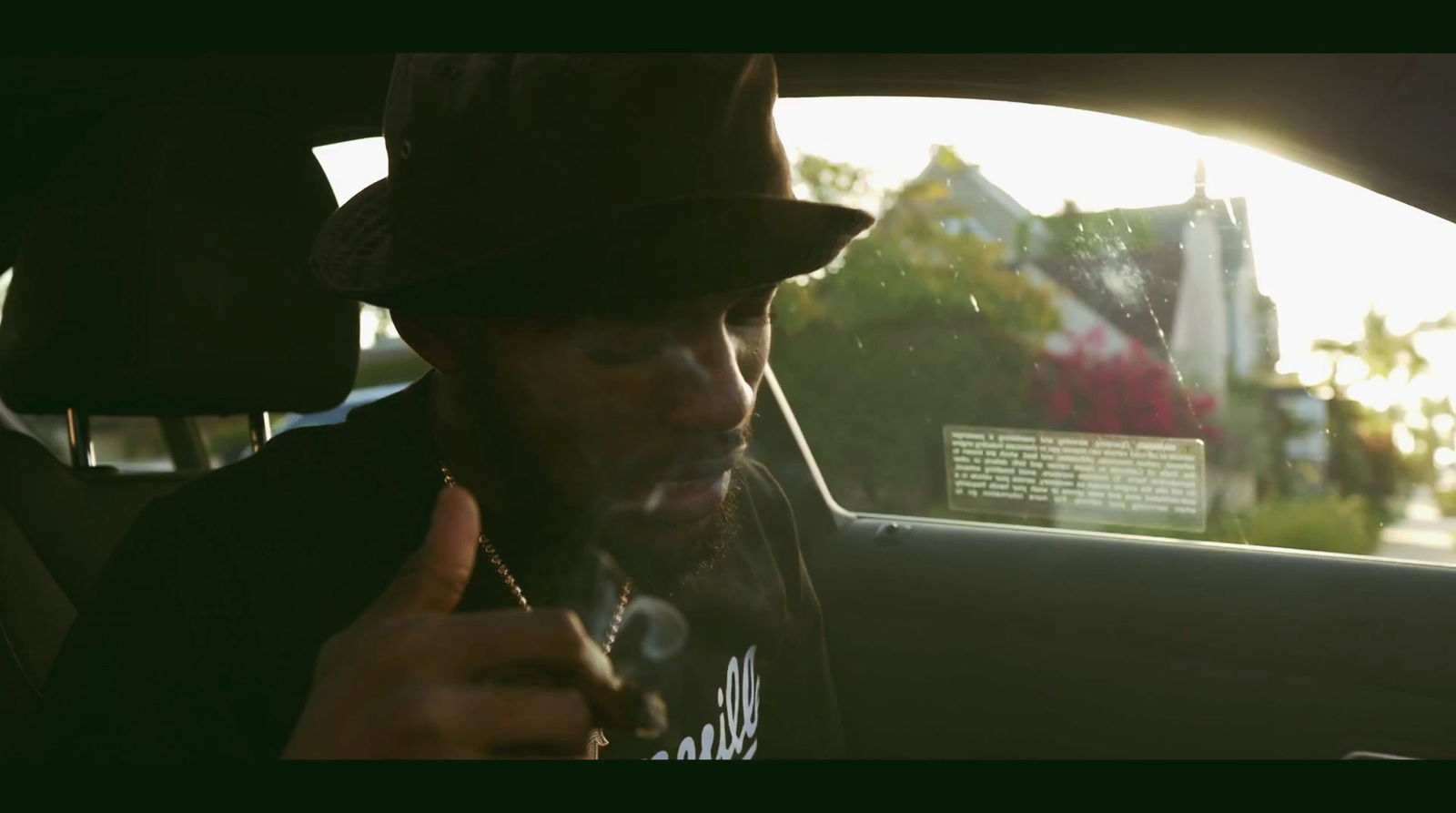 a man sitting in a car smoking a cigarette