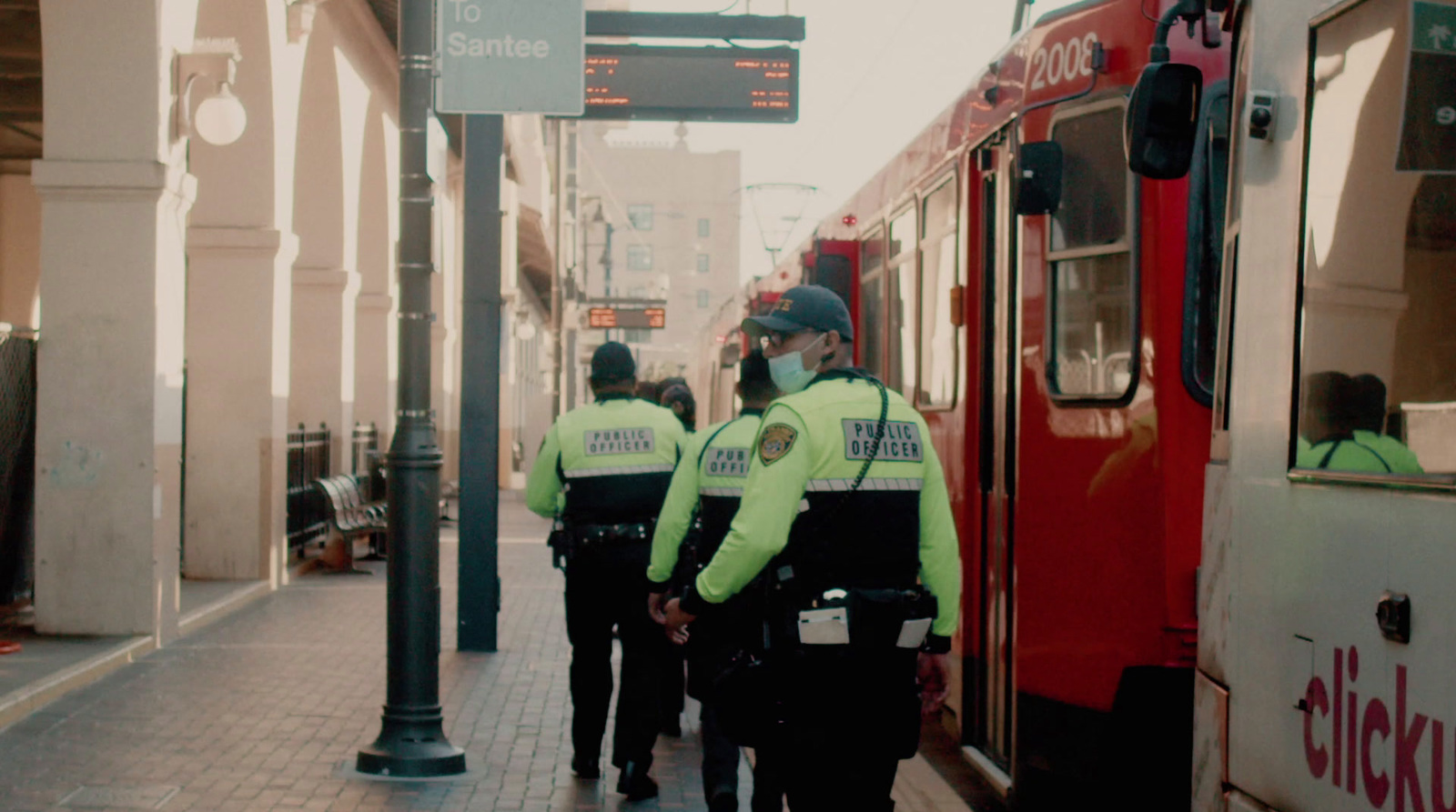 a group of police officers standing next to a train