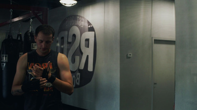 a man standing in front of a mirror in a gym