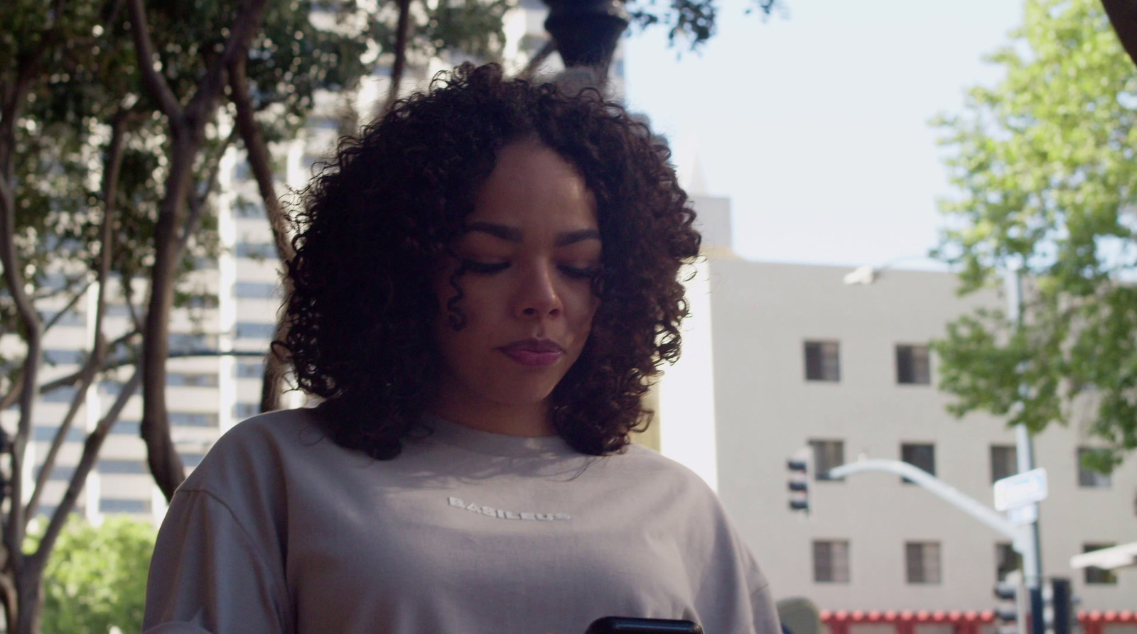 a woman looking down at her cell phone