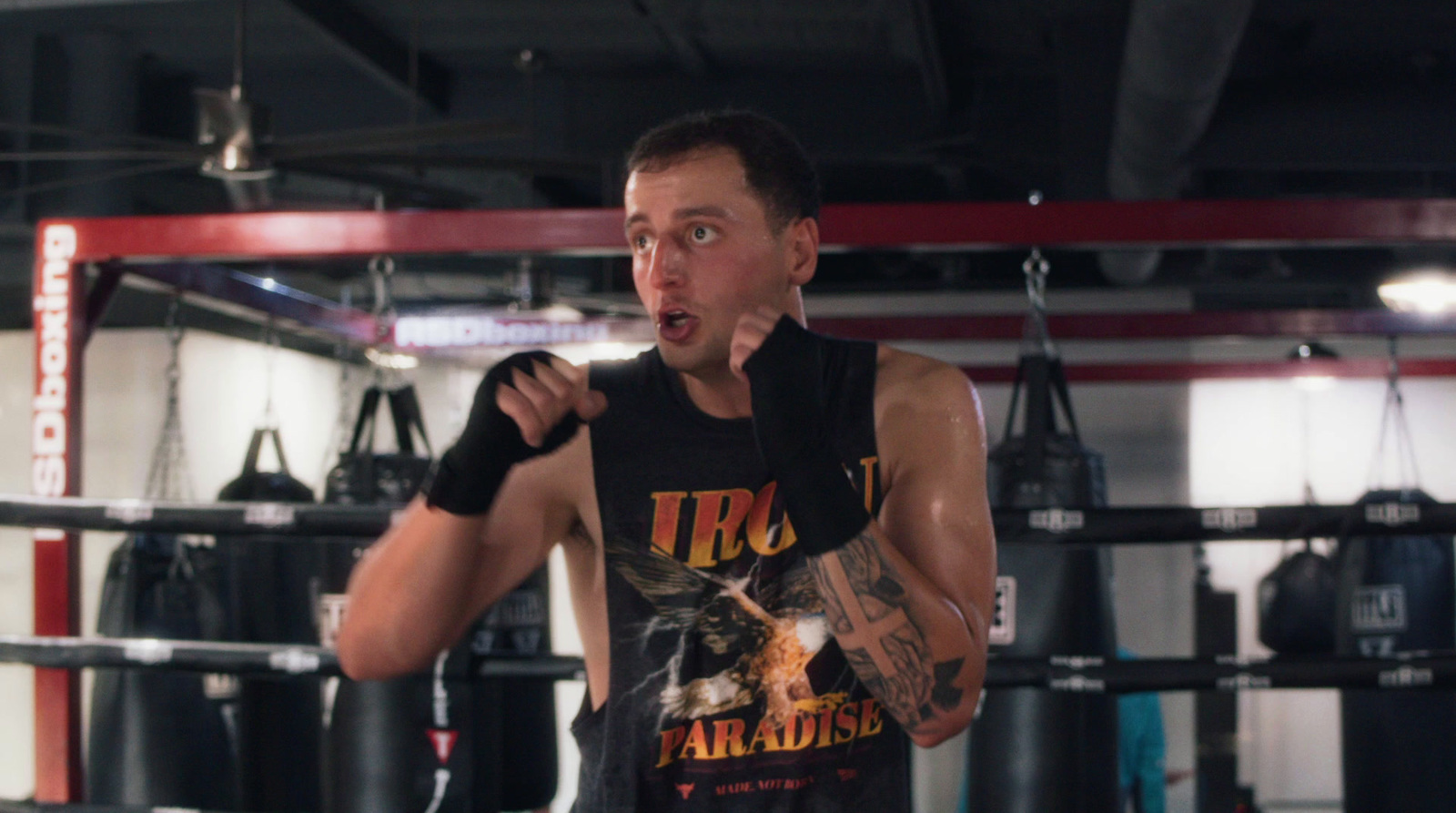 a man standing in a boxing ring with his mouth open