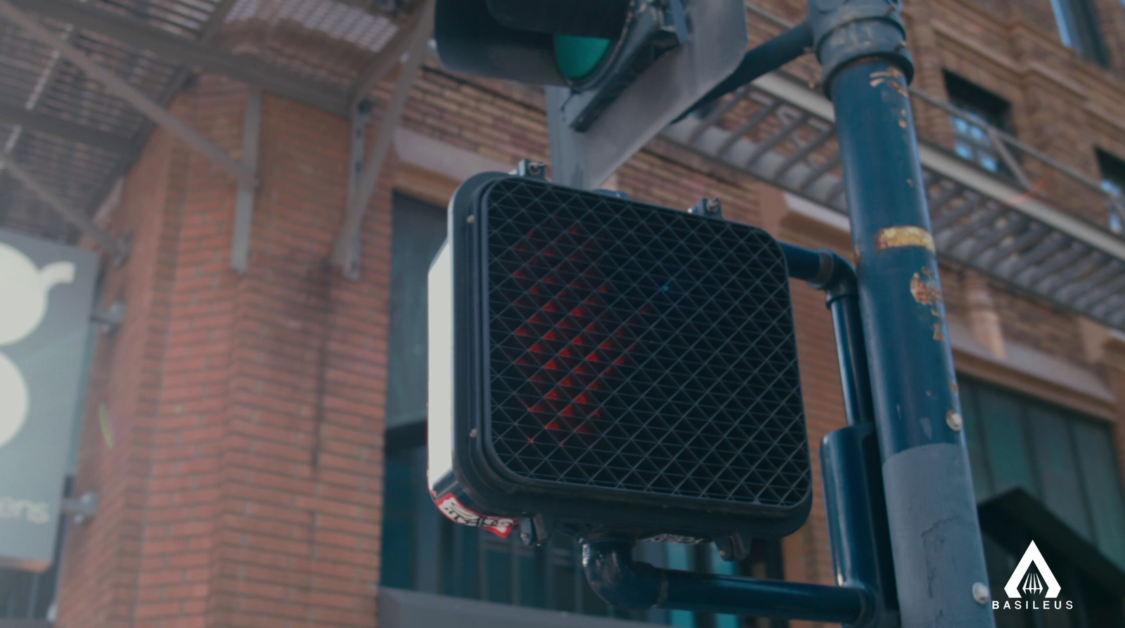 a traffic light on a pole in front of a building