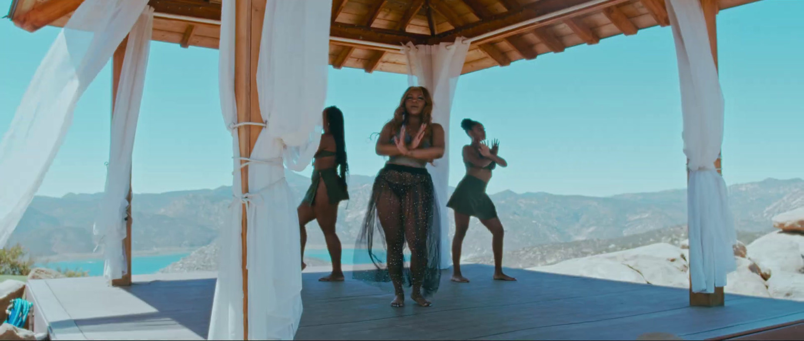 a group of women standing on top of a wooden platform