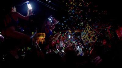 a group of people at a party with confetti and streamers