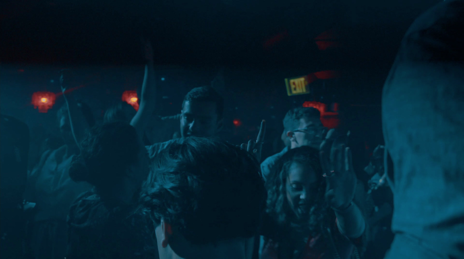 a group of people standing in a dark room