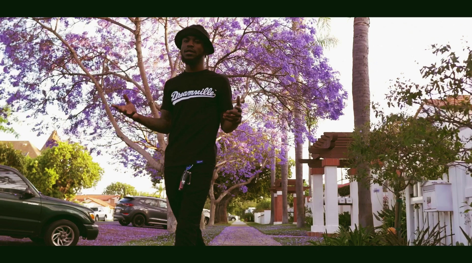 a man running down a sidewalk next to a tree