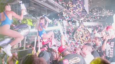 a group of people standing around a stage with confetti