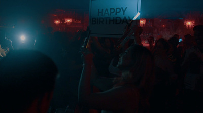 a group of people holding up a happy birthday sign