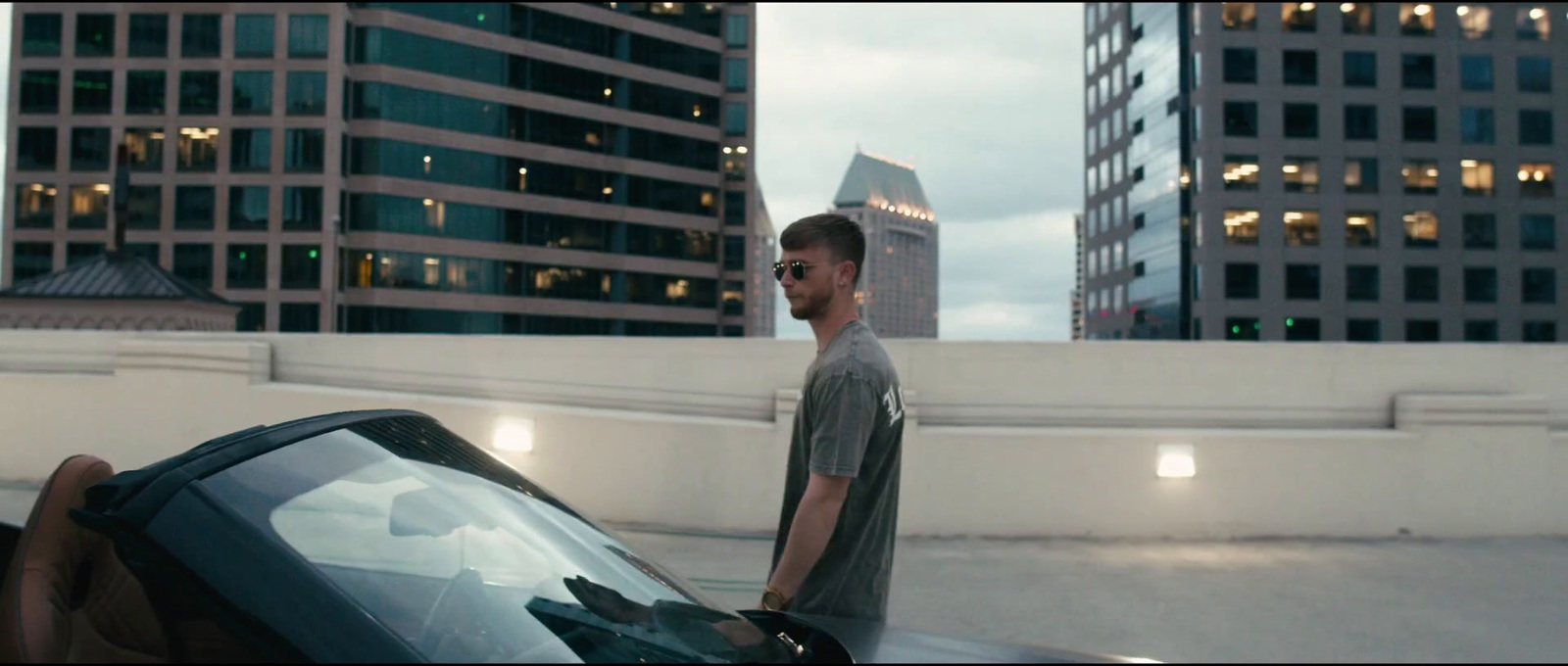 a man standing next to a car in a city