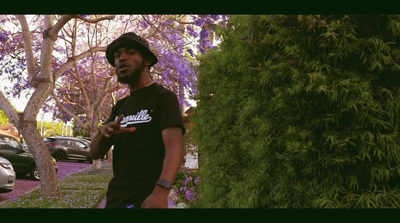 a man standing in front of a purple tree