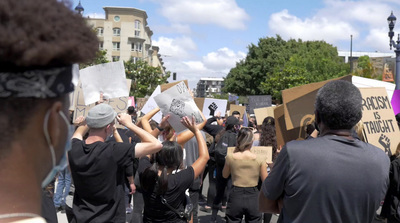 a group of people holding up signs in the street