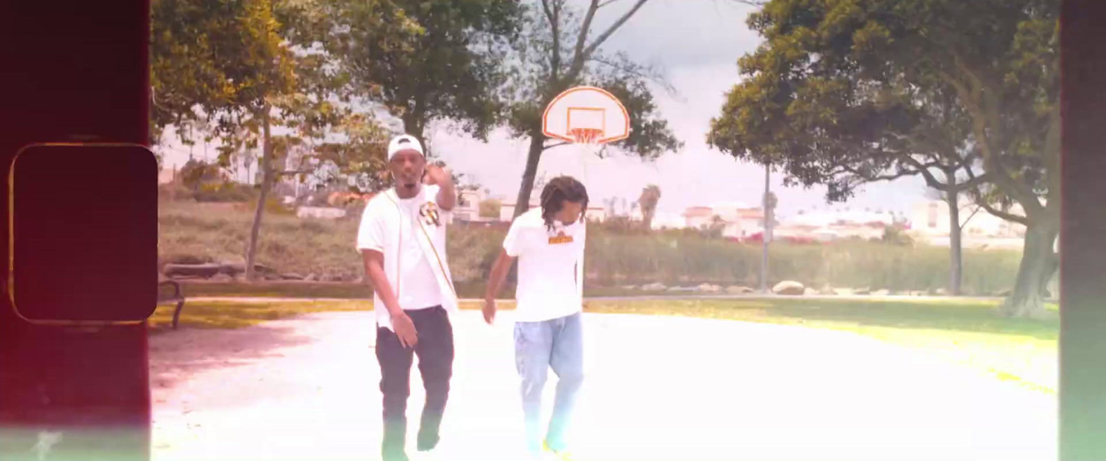 a couple of men standing next to a basketball hoop