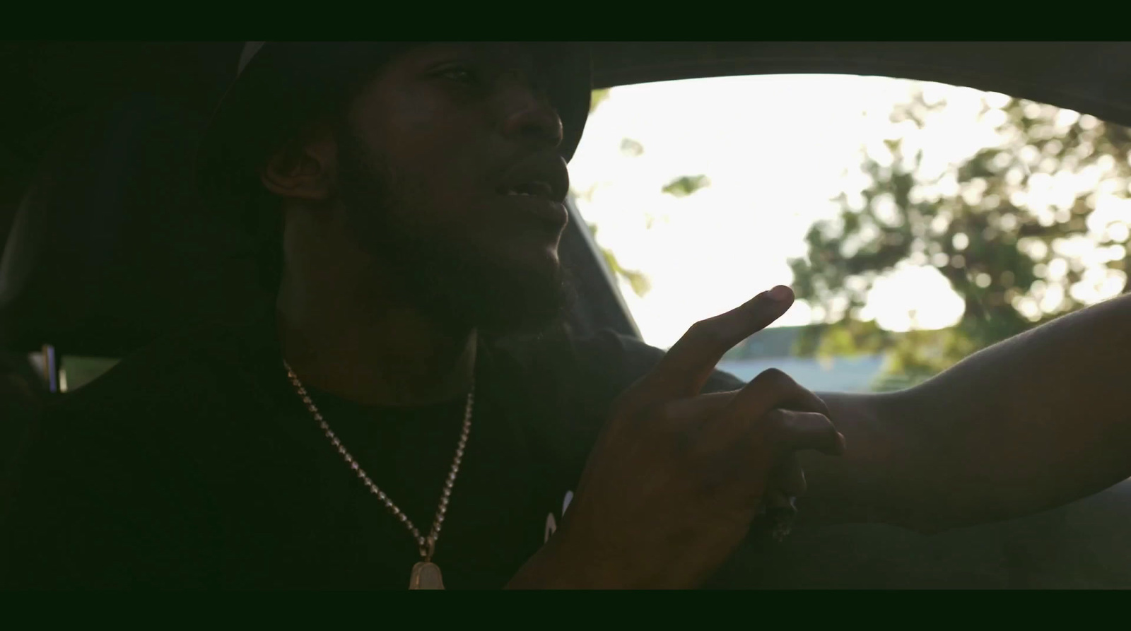 a man sitting in a car smoking a cigarette